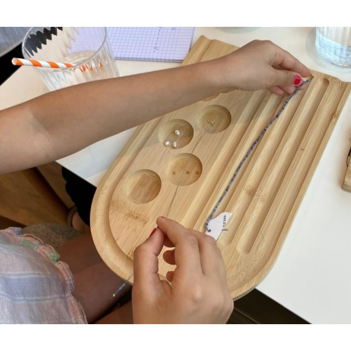 child making their own Murmures Precieux® dash and dot jewellery DIY bracelet and necklace-making workshop