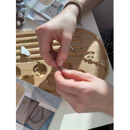 girl making their own Murmures Precieux® dash and dot jewellery DIY bracelet and necklace-making workshop